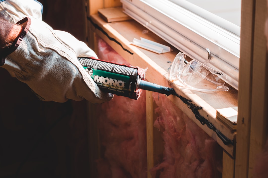 Gutter repair specialist resealing a separated gutter joint on a Jackson, TN home